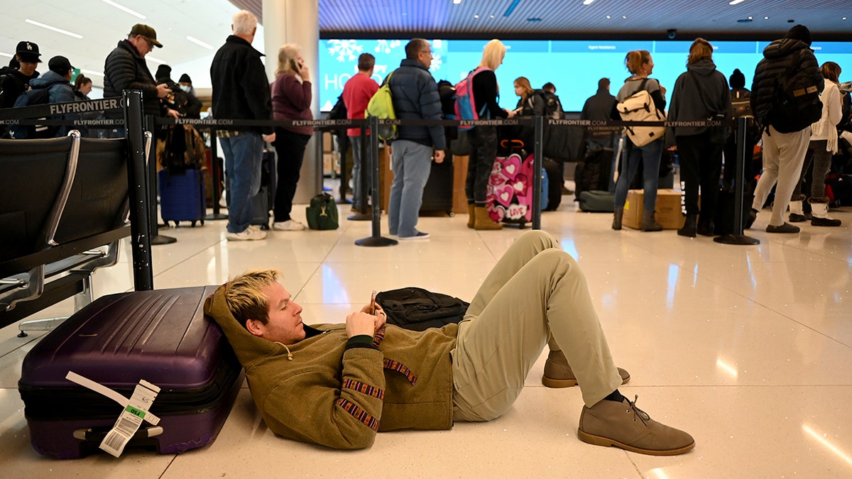 Denver airport passenger checks phone
