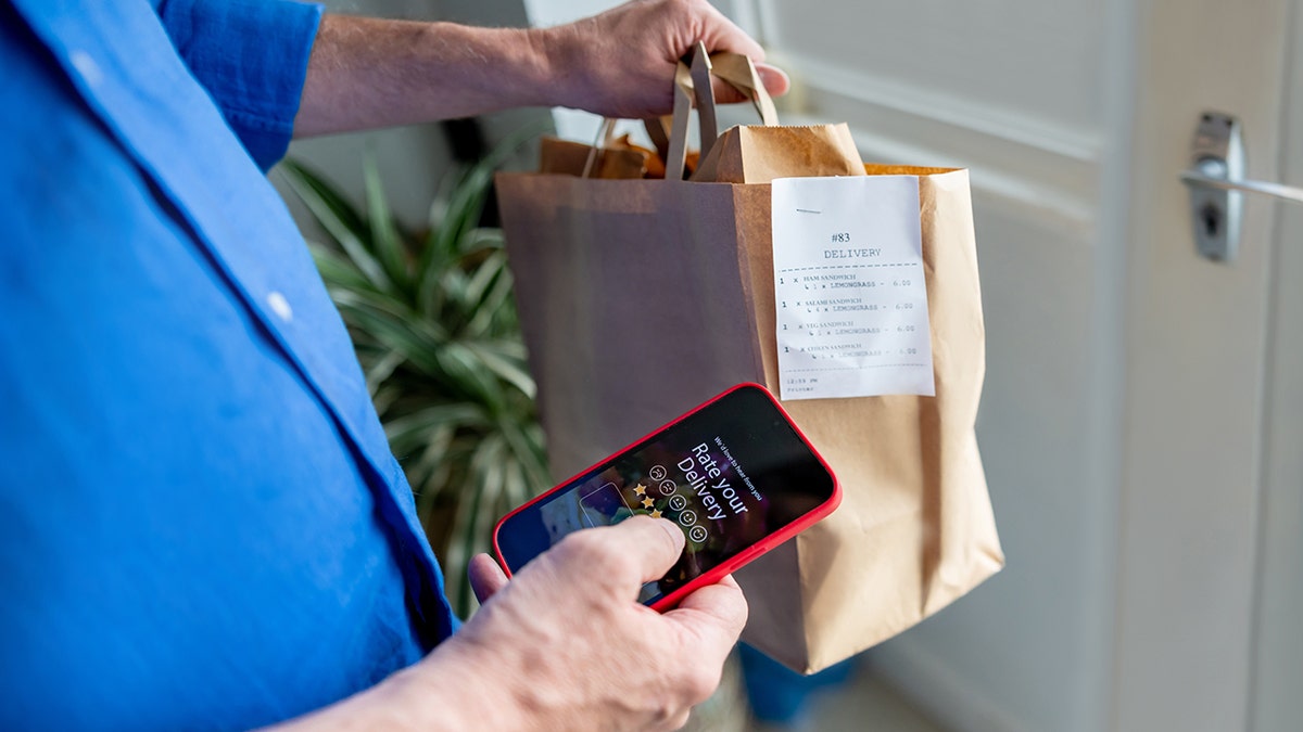 man rating his experience on the app after ordering food to his house
